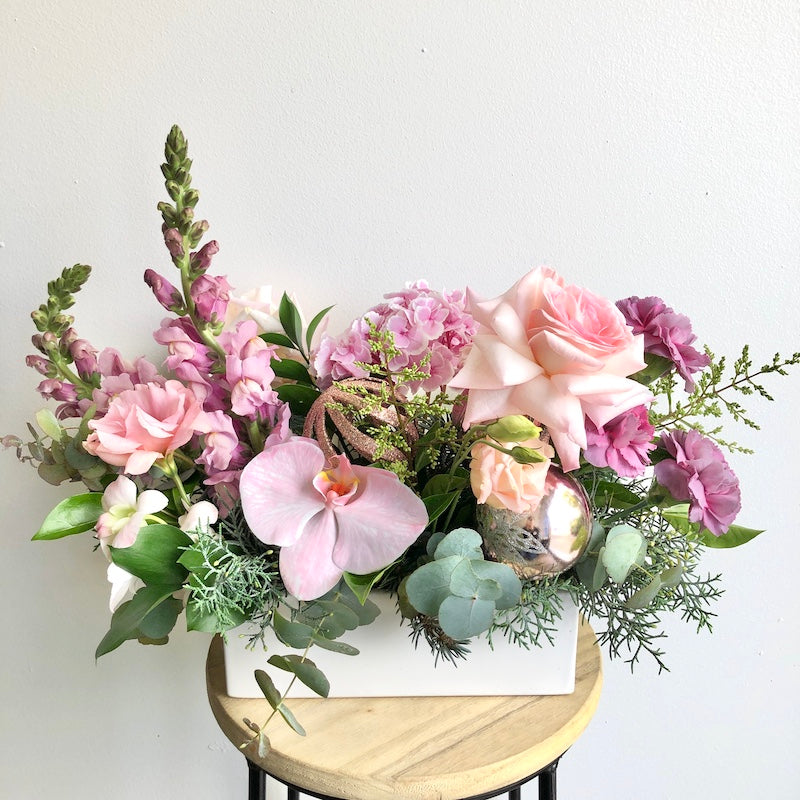 Christmas flower table centrepiece in pink and purple colours